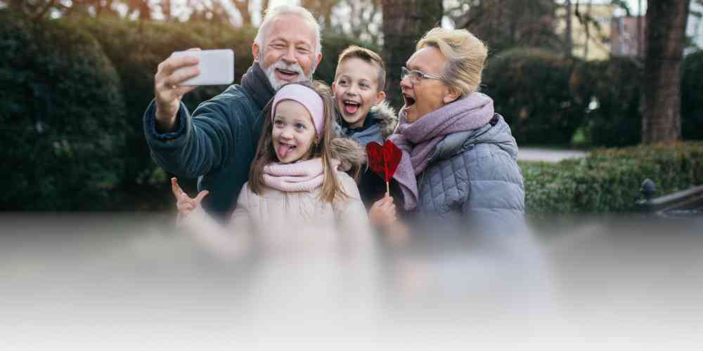 Grandparents taking silly selfies with grandchildren