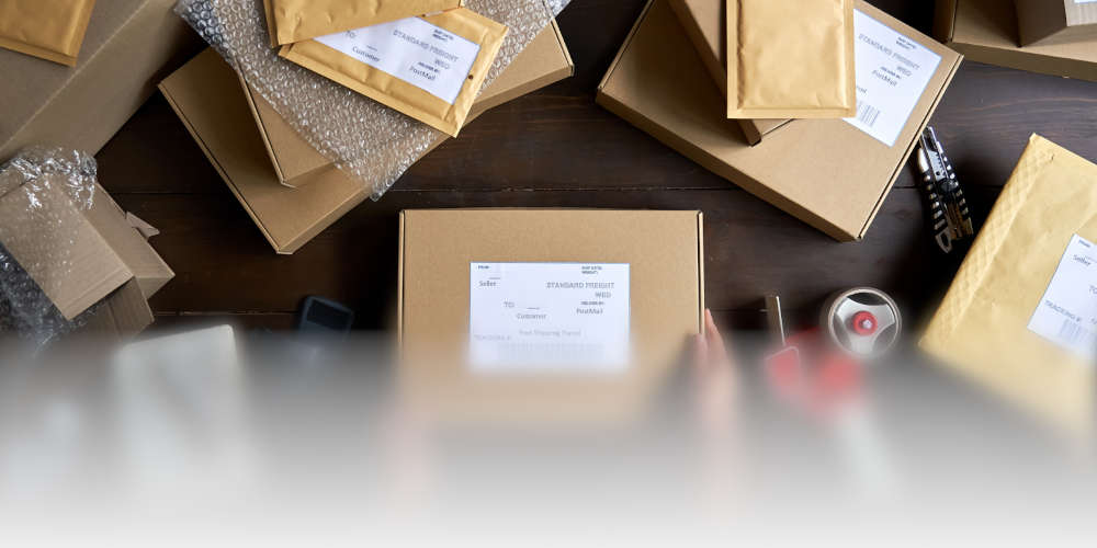 Table with shipping materials and an item ready to ship