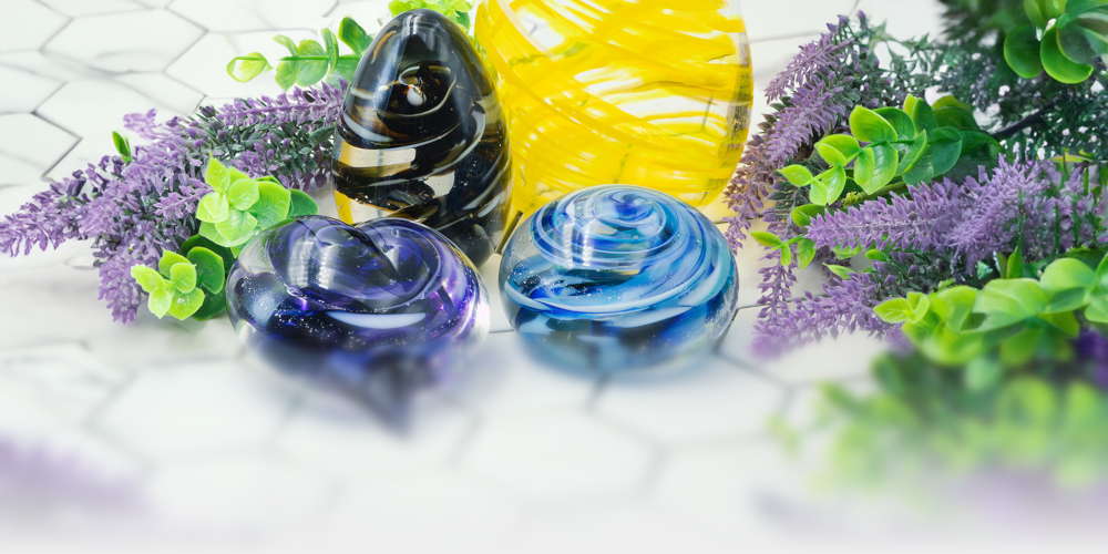 The Serenity Swirl collection, with a candle votive, paper weight, egg, and heart.