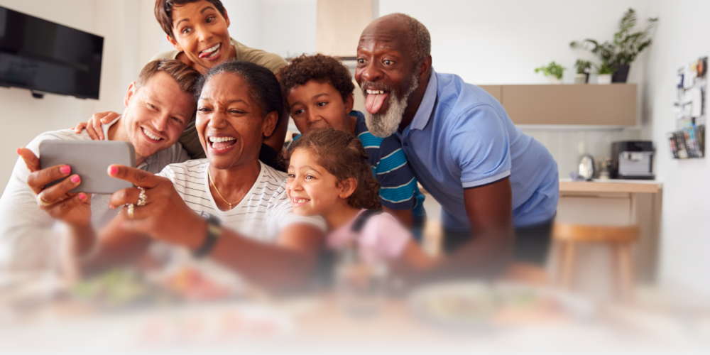 Grandparents with their family taking a silly selfie.