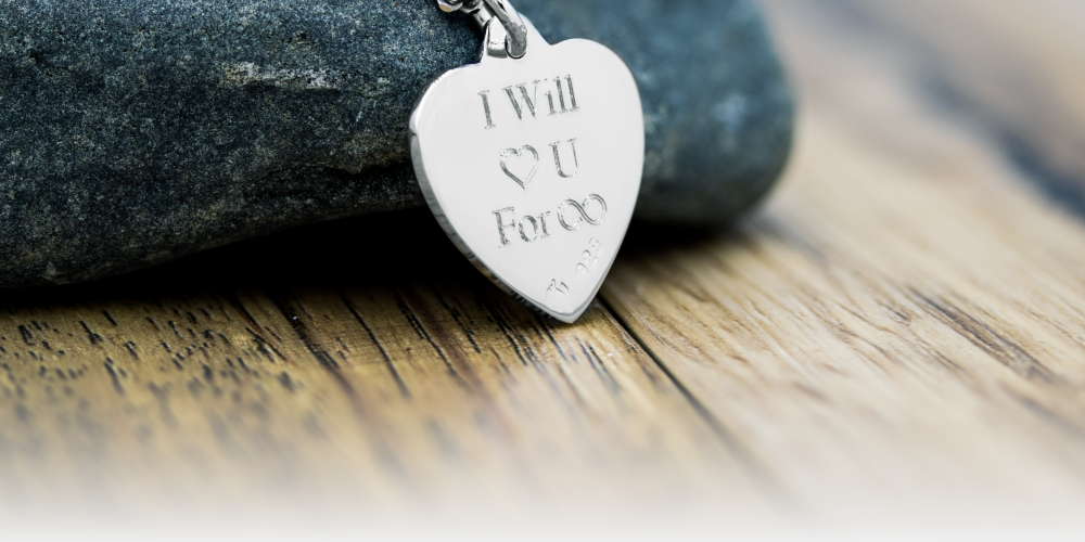 A classic heart pendant with "I will ❤️ u for ∞" engraved.
